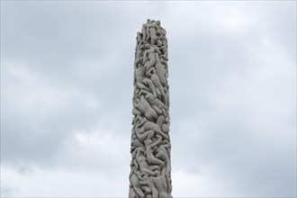 A stone pillar with intertwined bodies in Frogner Park, Pillar of Life, art, Oslo, Norway, Europe