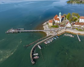 Moated castle peninsula with castle and parish church of St George on Lake Constance. Aerial view,
