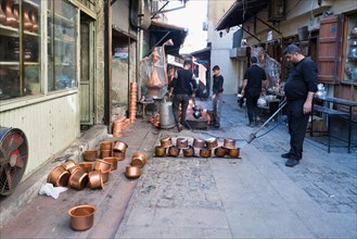 Artisan bleaching small copper containers, Gaziantep bazaar, Turkey, Asia