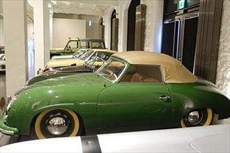 A green classic Porsche Cabriolet in an automobile exhibition, AUTOMUSEUM PROTOTYP, Hamburg,