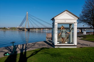 Monument to St Christopher the Great, patron saint of Riga, with the Daugava River and Vansu Bridge