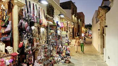 Lively street with souvenir shops and people at night, Lindos, Rhodes, Dodecanese, Greek Islands,
