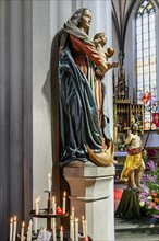 Figure of the Virgin Mary with baby Jesus and sacrificial candles, St Martin's Church, Kaufbeuern,