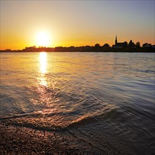Sunset over the Rhine in Neuss with a view of Volmerswerth in Duesseldorf, Lower Rhine, North