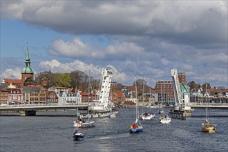 Sailing boats pass through open bascule bridge, Kappeln, Schlei, Schleswig-Holstein, Germany,