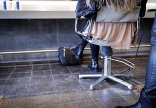 A customer sits on a hairdresser's chair, taken in the hairdressing salon Coiffeur Sivan in Berlin,