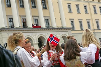 Several young ladies in old traditional costumes with national flags, The royal family on the
