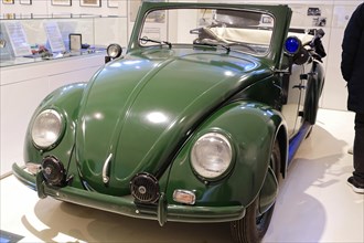 A green Volkswagen Beetle Cabriolet in shiny condition stands in the museum, AUTOMUSEUM PROTOTYP,
