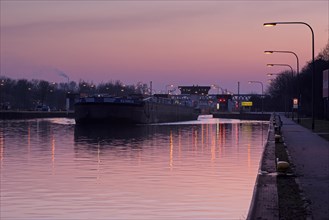 Lock on the Rhine-Herne Canal in Oberhausen-Lirich, at the blue hour, in the evening, a ship leaves