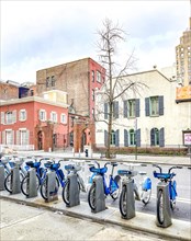 Parking station for rental e-bikes in front of the German House at New York University, Manhattan,