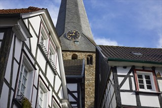 Tower clock of St George's Church and half-timbered houses in Hattingen, Ennepe-Ruhr district,