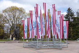 Latvian flags with the inscription Latvija Nato 20 fly at the monument to the teacher and poet