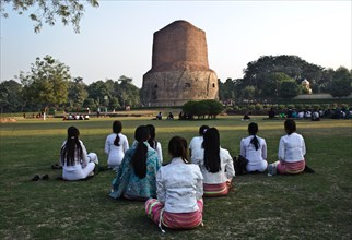 Buddhist young women from South east Asia, meditation in a buddhist pilgrimage site, Sarnath stupa,