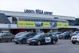 View of the airport building of the Latvian capital Riga, taxis of the company Bolt, Riga, Latvia,