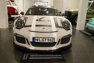 White Porsche 911 GT3 RS A Porsche 911 GT3 RS as a racing car concept at a car exhibition,