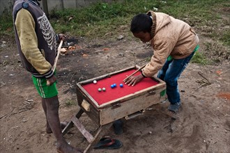 Boys, playing billiards, outside, Fianarantsoa, Madagascar, Africa