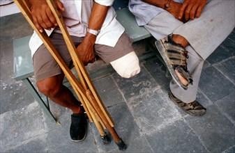 Leg amputee, crutches, relative, men, India, Asia