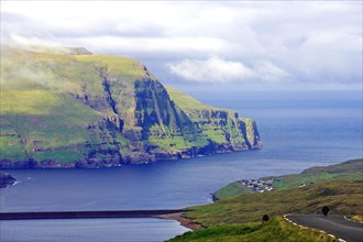 View over high mountains, cliffs and a mountain road, Eidi, Tjornuvik, Faroe Islands, Denmark,