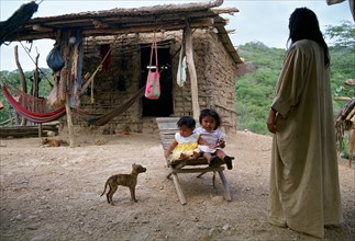 Grandmother, granddaughters, Wayuu tribe, La Guajira, Colombia. house, dog, family