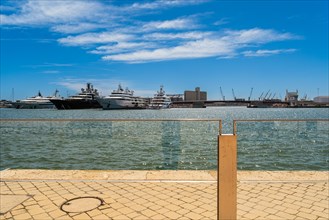 View of the marina of Tarragona with luxury yachts, clear blue sky and calm sea, Tarragona, Spain,