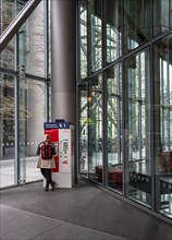 Woman standing at a Deutsche Bahn ticket machine, Berlin, Germany, Europe