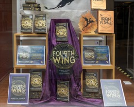 Book display 'Fourth Wing' by Rebecca Yarros in shop window of Waterstones bookshop, Ipswich,