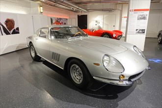 FERARI 275 GTB 4, A silver classic Ferrari, elegantly presented in a showroom for classic cars,