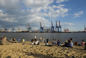 People on the beach, Strandbar Strandperle, Elbe beach, Hamburg harbour in the background,