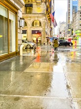 Rain-soaked pavements, 5th Ave, Midtown Manhattan, New York City