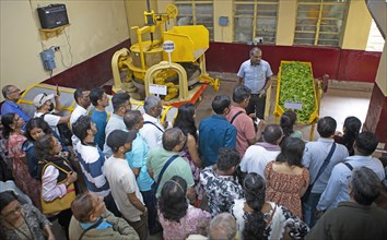 Indian visitors at a demonstration in the Munnar Tea Museum, Munnar, Kerala, India, Asia