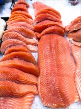Display of Pacific salmon (Oncorhynchus) caught by fishing in the form of salmon fillet on ice in