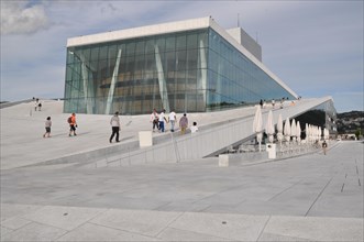 A futuristic building with people walking on the roof, wide glass front, new opera house, Oslo,