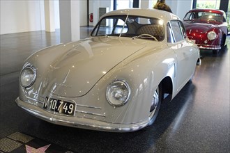 A grey Porsche 356 Coupe shown in the exhibition of a car dealership, AUTOMUSEUM PROTOTYP, Hamburg,