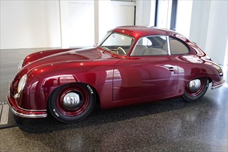 Side view of a red Porsche 356 Coupe in an exhibition hall, AUTOMUSEUM PROTOTYP, Hamburg, Hanseatic