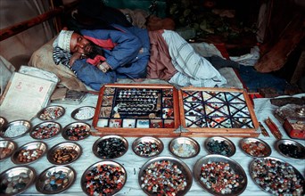 Vendor, selling semi precious stones, sleeping, muslim, Ajmer, India, Asia