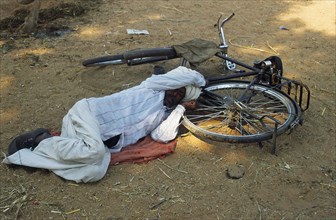 Sleeping on the ground, man, bicycle, rural, Rajasthan, India, Asia