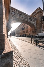Sunny street scene with a bridge building, clear sky and long shadows, Berlin, Germany, Europe