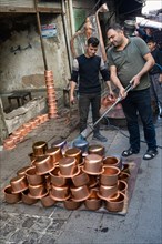 Artisan bleaching small copper containers, Gaziantep bazaar, Turkey, Asia
