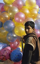 Boy selling balloons, Pakistan, Asia