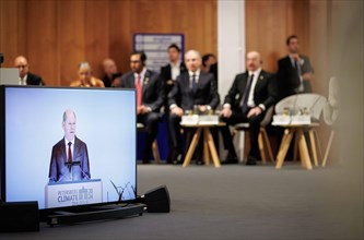 Olaf Scholz, Federal Chancellor, (on the monitor) during his speech at the Petersberg Climate