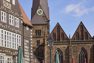 Detail of the tower and facade of the Church of Our Lady with house facades in Bremen, Hanseatic