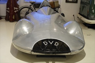 DELFOSSE DVD, front view of a silver vintage sports car with a DVV emblem in the museum, AUTOMUSEUM