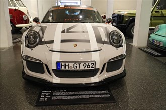 White Porsche 911 GT3 RS, Porsche sports car with distinctive GT stripes in an automobile