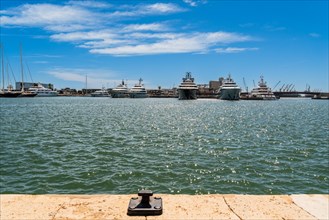 View of the marina of Tarragona with luxury yachts, clear blue sky and calm sea, Tarragona, Spain,