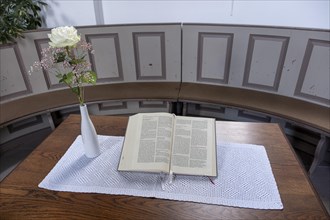 Open Bible next to a vase of flowers with a white Rose in the Protestant Reformed Church from 1401