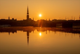 Sunrise on the Daugava River behind St Peter's Church, Riga, Latvia, Europe