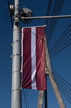 National flag of Latvia, hanging on the Vansu Bridge, Riga, Latvia, Europe