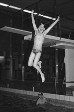 Boy jumping from the three-metre board, indoor swimming pool, Bamberg, Upper Franconia, Bavaria,