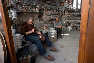 Artisan engraving a copper plate, Mardin bazaar, Turkey, Asia