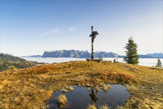 Cross on the Hochkeil with the Tennengebirge in the background, autumn, fog in the valley,